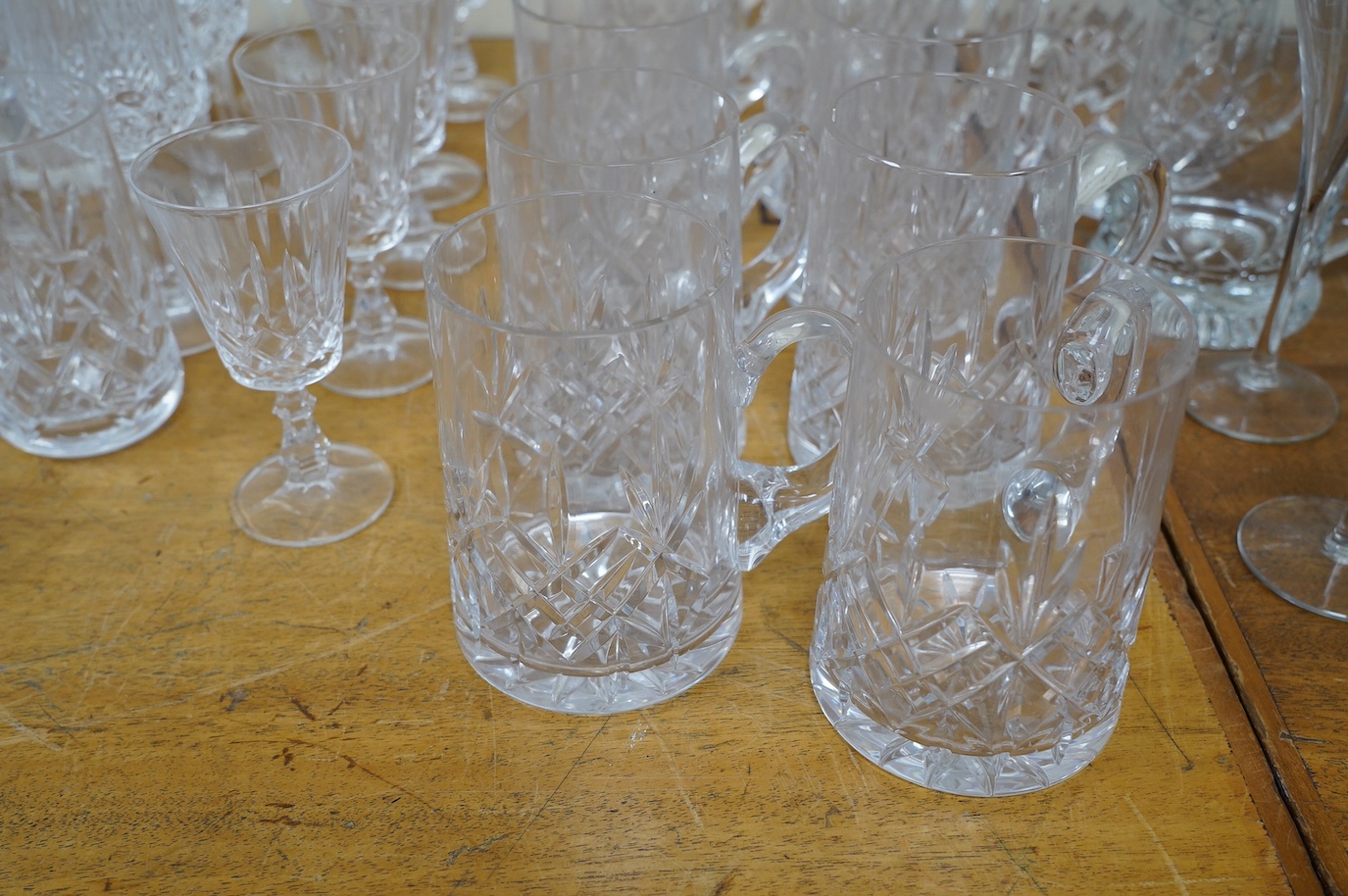 A collection of crystal glassware to include a set of ten tankards, wine glasses and tumblers, tallest 19cm. Condition - varies, mostly fair